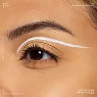 Close-up of an eye wearing NYX Professional Makeup Party Animals Epic Ink Liner in Phantom Lines as a crisp white graphic eyeliner design.
