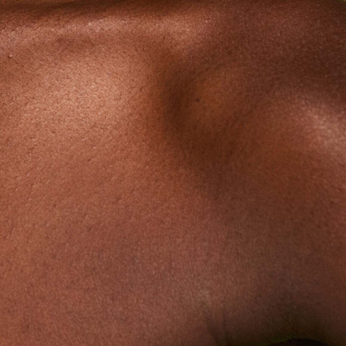 Image of the model’s chest before applying NYX Professional Makeup Fat Oil Body Oil in Caramelt Mami.
